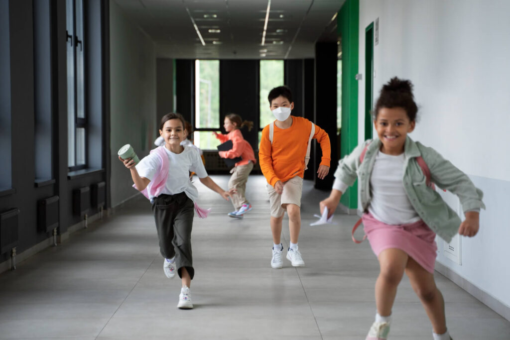 Crianças correndo agitadas pelo corredor. Entenda a avaliação neuropsicológica para diagnóstico de TDAH infantil no ABC paulista.